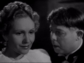 Movie still from “The Rules of the Game” (1939), directed by Jean Renoir – An old photo of a woman and a boy; Close Up shot, Over the shoulder angle