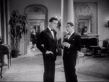 Movie still from “The Rules of the Game” (1939), directed by Jean Renoir – Two men in tuxedos standing next to each other; Medium shot, High angle