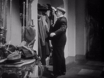 Movie still from “The Rules of the Game” (1939), directed by Jean Renoir – An old photo of a man looking in a mirror; Medium shot, Over the shoulder angle