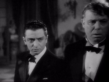 Movie still from “The Rules of the Game” (1939), directed by Jean Renoir – A black and white photo of a man in a tuxedo; Close Up shot, Low angle