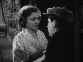 Movie still from “The Rules of the Game” (1939), directed by Jean Renoir – An old photo of a man and a woman talking to each other; Close Up shot, High angle