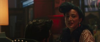 Movie still from “The Runaways” (2010), directed by Floria Sigismondi – A man and a woman sitting at a table talking to each other; Close Up shot, Over the shoulder angle