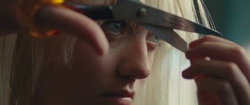 Movie still from “The Runaways” (2010), directed by Floria Sigismondi – A person holding a pair of shears; Extreme Close Up shot, Over the shoulder angle