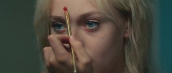 Movie still from “The Runaways” (2010), directed by Floria Sigismondi – A woman holding a match in her hand; Extreme Close Up shot, Over the shoulder angle