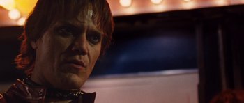 Movie still from “The Runaways” (2010), directed by Floria Sigismondi – A man's face in front of lights; Close Up shot, Low angle