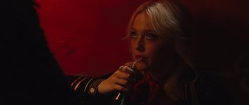 Movie still from “The Runaways” (2010), directed by Floria Sigismondi – A woman holding a phone in her hand; Close Up shot, High angle