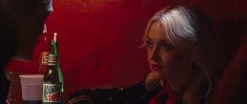 Movie still from “The Runaways” (2010), directed by Floria Sigismondi – A woman with blonde hair and red lipstick looking into the camera; Close Up shot, High angle