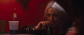 Movie still from “The Runaways” (2010), directed by Floria Sigismondi – A woman with blonde hair is leaning on a bar; Close Up shot, Over the shoulder angle