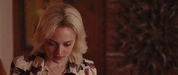 Movie still from “The Runaways” (2010), directed by Floria Sigismondi – A woman with blonde hair is looking down at her face; Close Up shot, Over the shoulder angle