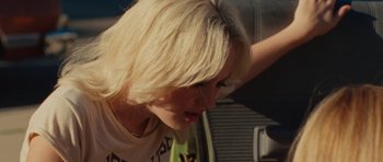 Movie still from “The Runaways” (2010), directed by Floria Sigismondi – A woman with blonde hair is looking down at her face; Close Up shot, Over the shoulder angle