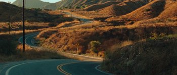 Movie still from “The Runaways” (2010), directed by Floria Sigismondi – A winding road in the middle of the desert; Extreme Wide shot, High angle