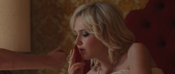 Movie still from “The Runaways” (2010), directed by Floria Sigismondi – A woman is talking on a cell phone; Close Up shot, Over the shoulder angle