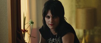 Movie still from “The Runaways” (2010), directed by Floria Sigismondi – A person sitting on a chair; Close Up shot, Over the shoulder angle