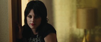 Movie still from “The Runaways” (2010), directed by Floria Sigismondi – A person sitting in front of a wall; Close Up shot, Over the shoulder angle