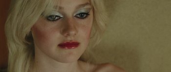 Movie still from “The Runaways” (2010), directed by Floria Sigismondi – A person with makeup on; Close Up shot, High angle