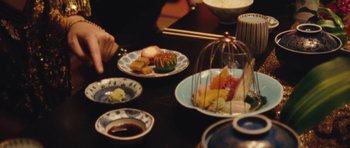 Movie still from “The Runaways” (2010), directed by Floria Sigismondi – A table topped with plates and bowls filled with food; Extreme Close Up shot, High angle