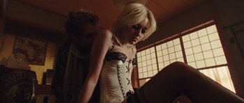 Movie still from “The Runaways” (2010), directed by Floria Sigismondi – A man and a woman wearing lingerie in front of a window; Medium shot, Low angle