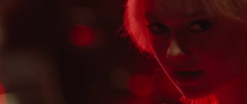 Movie still from “The Runaways” (2010), directed by Floria Sigismondi – A woman with red hair is looking at the camera; Extreme Close Up shot, Low angle