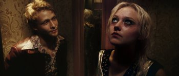 Movie still from “The Runaways” (2010), directed by Floria Sigismondi – A woman looking into a mirror next to another woman; Close Up shot, Over the shoulder angle