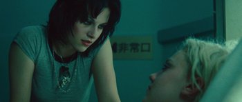 Movie still from “The Runaways” (2010), directed by Floria Sigismondi – A young woman looking at a young man in a room; Close Up shot, Over the shoulder angle