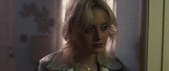 Movie still from “The Runaways” (2010), directed by Floria Sigismondi – A woman with blonde hair wearing a star necklace; Close Up shot, High angle