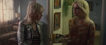 Movie still from “The Runaways” (2010), directed by Floria Sigismondi – Two women standing next to each other in front of a mirror; Medium shot, Over the shoulder angle