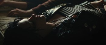 Movie still from “The Runaways” (2010), directed by Floria Sigismondi – A woman laying on the ground with her hands on her chest; Close Up shot, Overhead angle