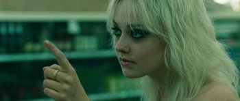 Movie still from “The Runaways” (2010), directed by Floria Sigismondi – A person holding a cell phone; Close Up shot, Over the shoulder angle