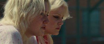 Movie still from “The Runaways” (2010), directed by Floria Sigismondi – Two blonde haired women looking at each other; Close Up shot, Low angle