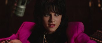 Movie still from “The Runaways” (2010), directed by Floria Sigismondi – A person wearing a pink jacket; Close Up shot, Over the shoulder angle
