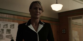 Movie still from “House of Cards” (2013), created by Beau Willimon – A person wearing a suit and tie; Medium shot, Low angle