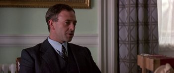 Movie still from “The Russia House” (1990), directed by Fred Schepisi – A person wearing a suit and tie; Close Up shot, Low angle