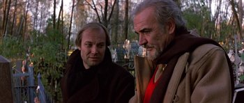 Movie still from “The Russia House” (1990), directed by Fred Schepisi – Two men are standing next to each other outside; Close Up shot, Low angle