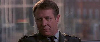 Movie still from “The Russia House” (1990), directed by Fred Schepisi – A person wearing a military uniform; Close Up shot, Low angle