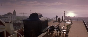 Movie still from “The Russia House” (1990), directed by Fred Schepisi – People walking on a boardwalk near the ocean; Extreme Wide shot, Low angle