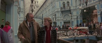 Movie still from “The Russia House” (1990), directed by Fred Schepisi – A man and a woman walking down a street; Medium shot, Low angle