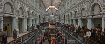 Movie still from “The Russia House” (1990), directed by Fred Schepisi – A crowd of people walking around in a building; Extreme Wide shot, High angle