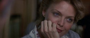 Movie still from “The Russia House” (1990), directed by Fred Schepisi – A person with a hand on her face; Close Up shot, Over the shoulder angle