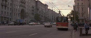 Movie still from “The Russia House” (1990), directed by Fred Schepisi – A street scene with cars and a tram; Wide shot, High angle