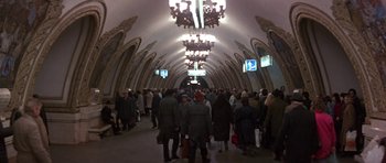 Movie still from “The Russia House” (1990), directed by Fred Schepisi – A group of people standing in a subway station; Extreme Wide shot, High angle