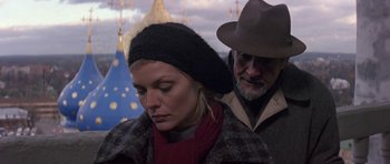 Movie still from “The Russia House” (1990), directed by Fred Schepisi – A man and a woman standing next to each other; Close Up shot, Low angle