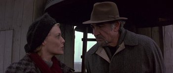 Movie still from “The Russia House” (1990), directed by Fred Schepisi – A man and a woman are standing under an umbrella; Close Up shot, Low angle