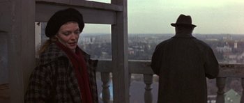 Movie still from “The Russia House” (1990), directed by Fred Schepisi – A woman and a man standing next to each other on top of a building; Medium shot, Over the shoulder angle