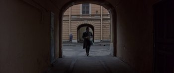 Movie still from “The Russia House” (1990), directed by Fred Schepisi – A man walking down a street in a tunnel; Wide shot, Low angle