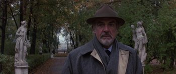 Movie still from “The Russia House” (1990), directed by Fred Schepisi – An older man wearing a hat and a coat; Close Up shot, Low angle