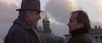 Movie still from “The Russia House” (1990), directed by Fred Schepisi – Two men talking to each other in front of a building; Close Up shot, Low angle
