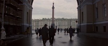 Movie still from “The Russia House” (1990), directed by Fred Schepisi – A group of people walking on a sidewalk near a building; Extreme Wide shot, Low angle