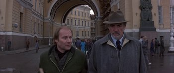 Movie still from “The Russia House” (1990), directed by Fred Schepisi – Two men walking down the street in front of a building; Medium shot, Low angle