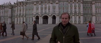 Movie still from “The Russia House” (1990), directed by Fred Schepisi – Two men are walking in front of a large building; Medium shot, Low angle