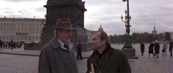 Movie still from “The Russia House” (1990), directed by Fred Schepisi – Two men are standing on the sidewalk talking; Medium shot, Over the shoulder angle
